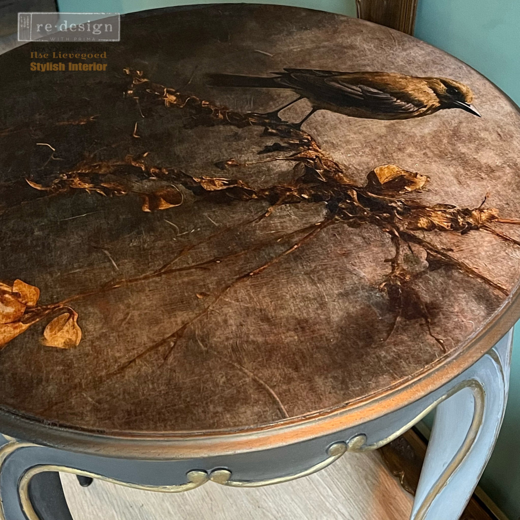 A round wood table refurbished by Ilse Lievgoed features ReDesign with Prima's Rustic Refuge fiber paper on the table top.