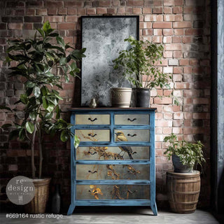 A chest dresser is painted blue and features ReDesign with Prima's Rustic Refuge A1 fiber paper on its 7 drawers.