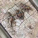 A silicone mould casting of two royal lions wearing crowns are facing a royal crest and are against Redesign with Prima's La Spaccatura tissue paper.