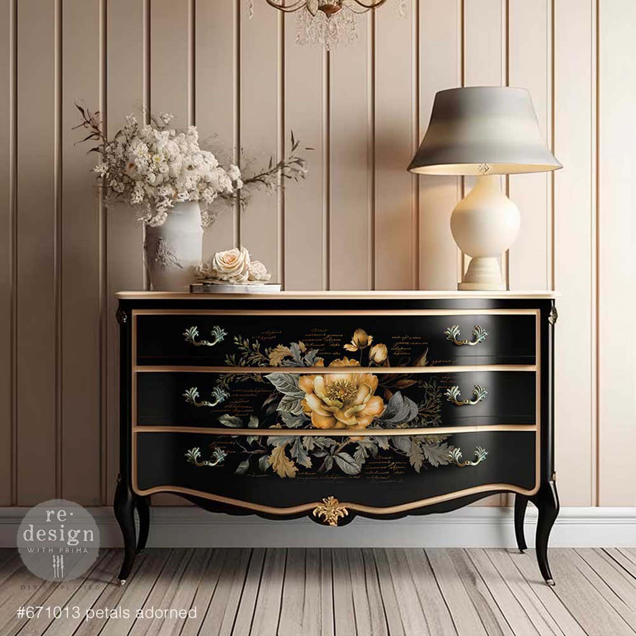 A vintage 3-drawer dresser is painted black with gold trim and features one sheet of ReDesign with Prima's Petals Adorned tissue paper in the center of all 3 drawers.