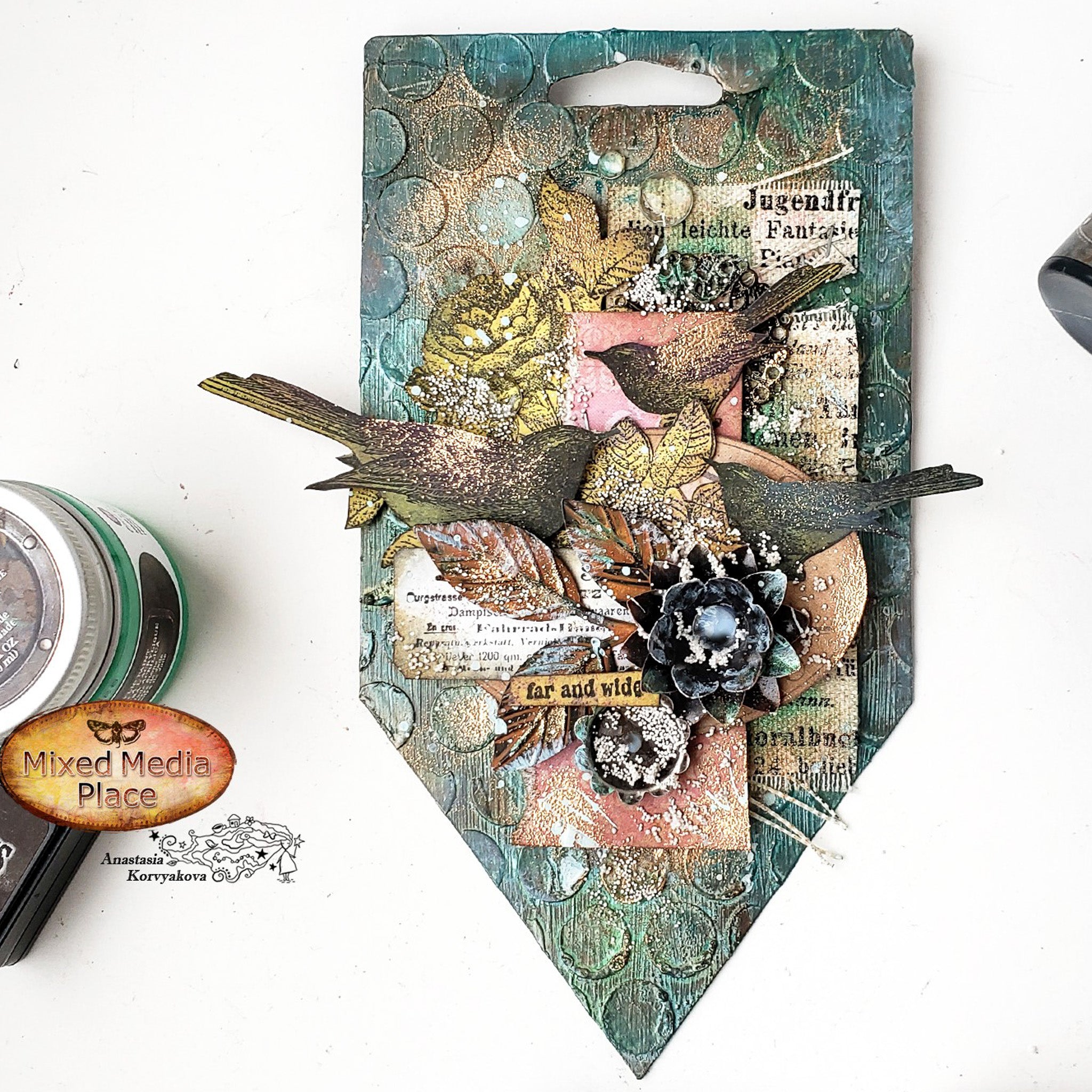 A decor piece featuring Finnabair's Modeling Paste along with scrapbooking birds and flowers is against a white background.