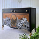 A vintage dresser is painted black with a natural wood stain and features the Abstract Jungle transfer on its drawers.