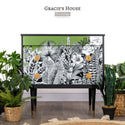 A modern dresser refurbished by Gracie's House, a ReDesign Brand Ambassador, is painted black and avocado green and features the Abstract Jungle transfer on its drawers.