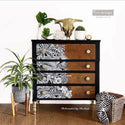 A modern 4-drawer dresser refurbished by Rachael, a ReDesign Content Creator, is painted black and features a natural wood stain and the Abstract Jungle transfer on its drawers.