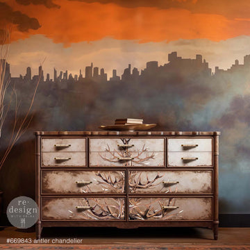 A vintage 10-drawer dresser is painted brown and features ReDesign with Prima's Antler Chandelier transfer down the center of the drawers.
