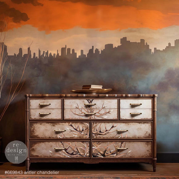 A vintage 10-drawer dresser is painted brown and features ReDesign with Prima's Antler Chandelier transfer down the center of the drawers.