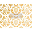 Gold foil rub-on transfer design of a leafy scroll damask pattern is on a white background.