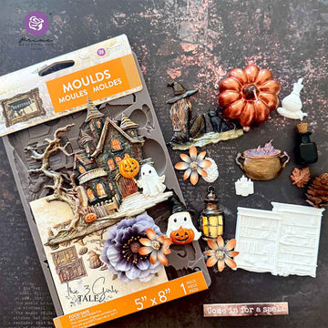 Halloween-themed mold set with decorative items on a dark surface