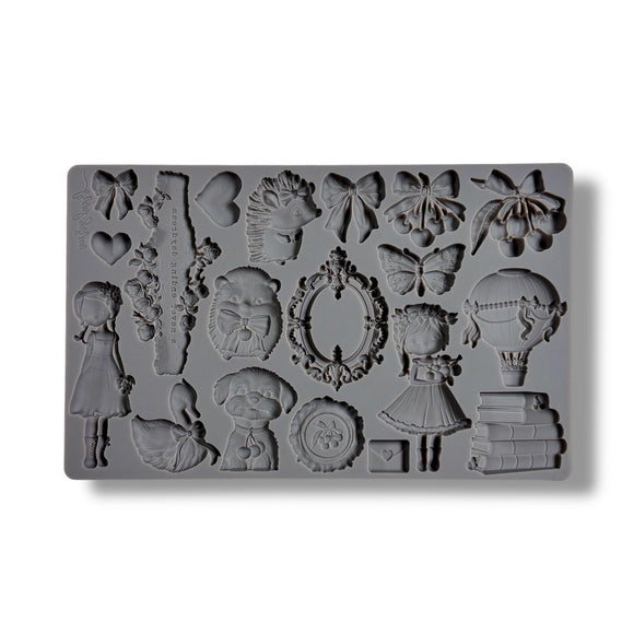 Gray silicone mold with decorative shapes on a white background