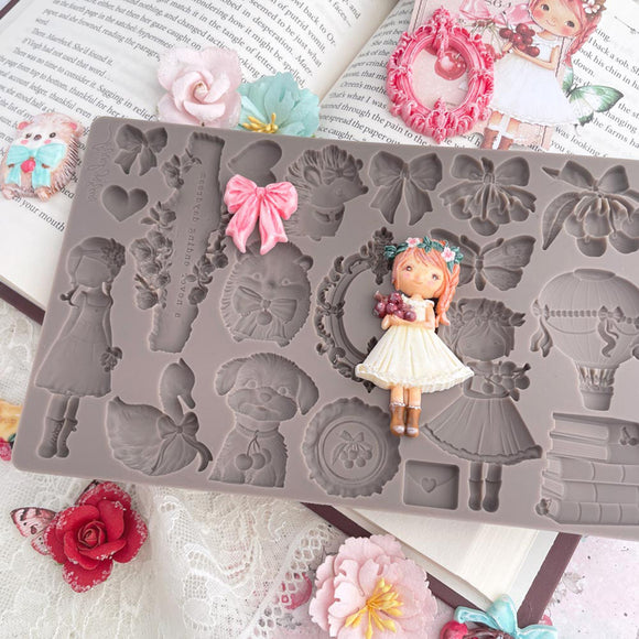 Silicone mold with decorative elements on a floral and book-themed background