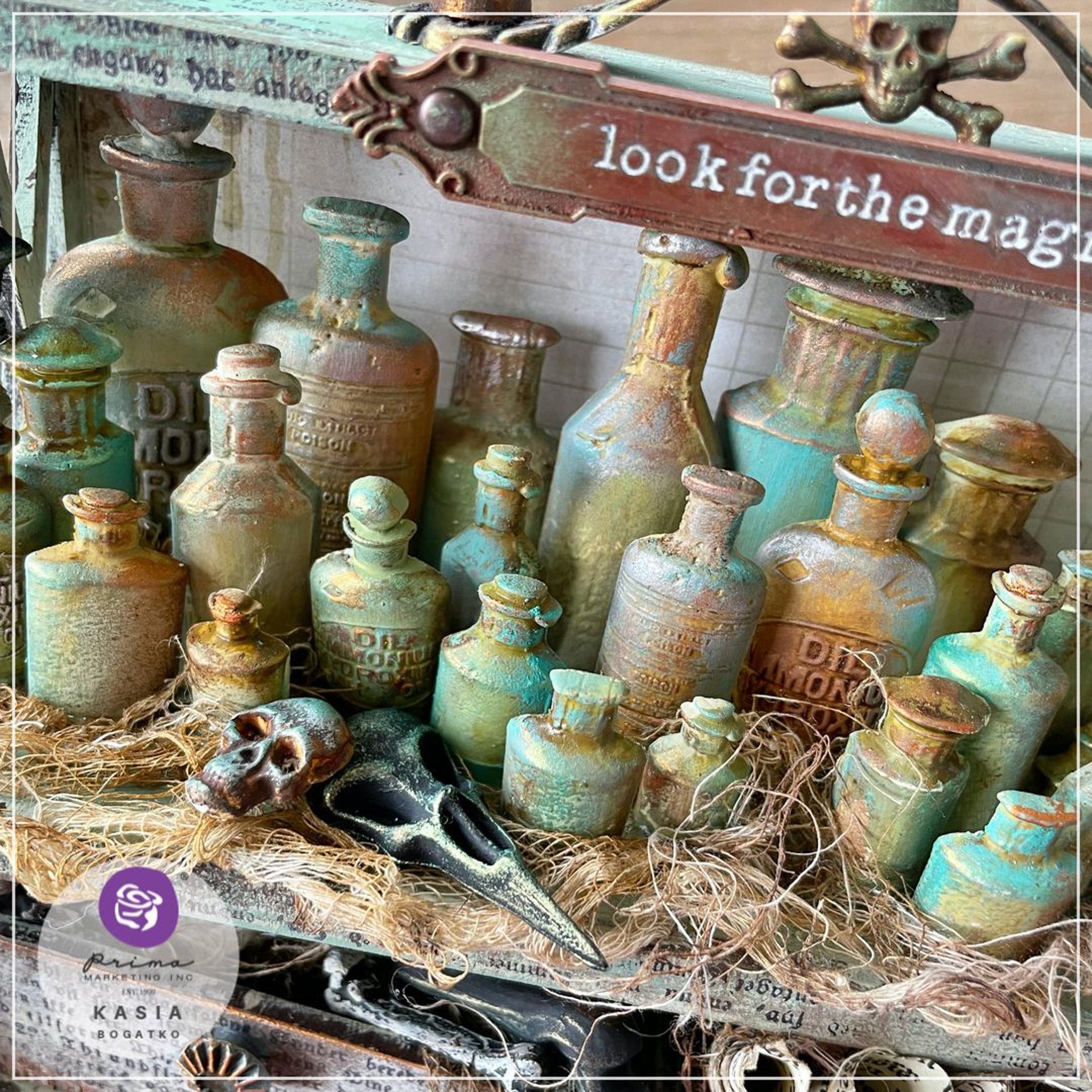 Close-up of rustic patina-colored silicone mold castings from Finnabair's Apothecary Bottles Silicone Mold are set up on a spooky decorated shelf.