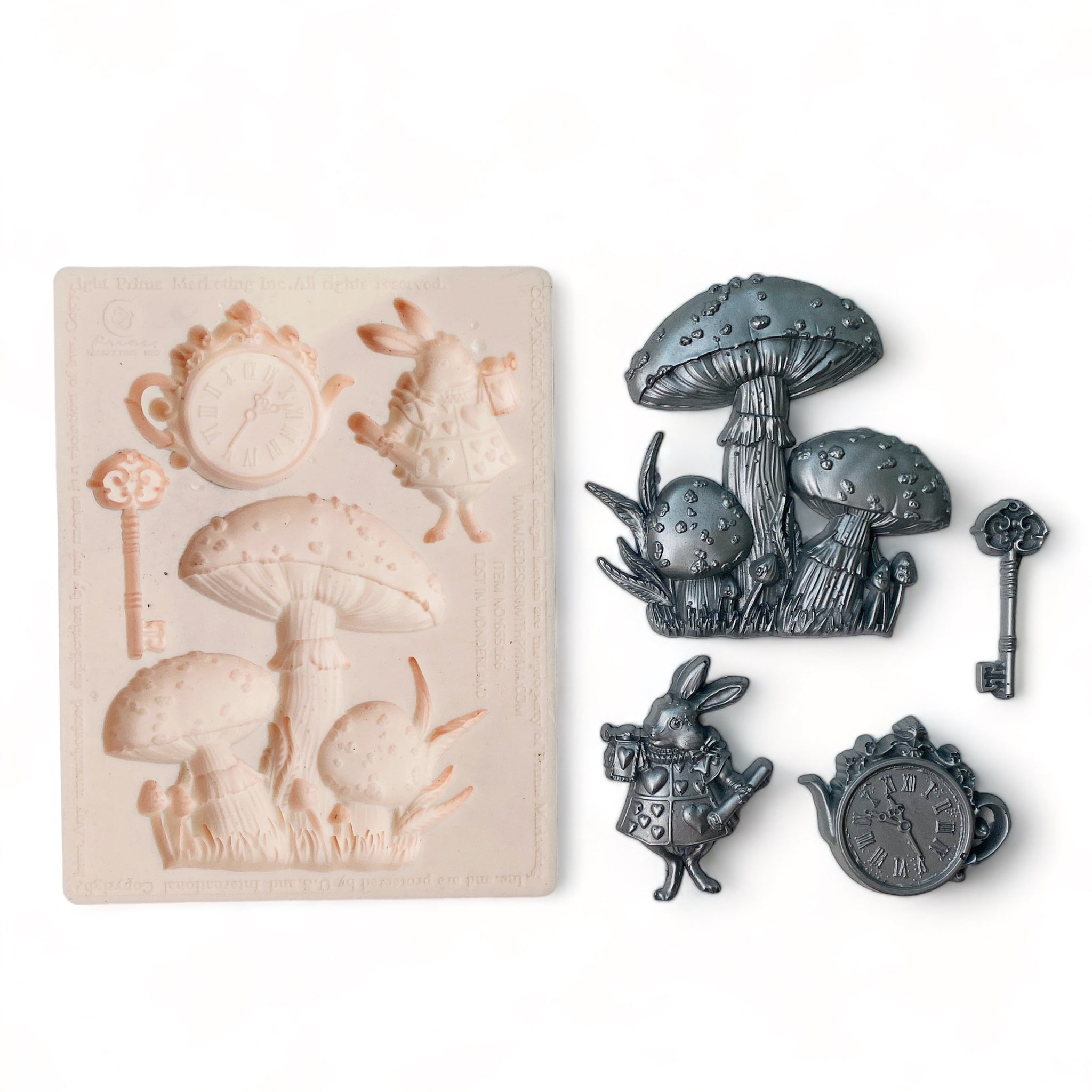 A beige silicone mold and silver colored castings of Alice in Wonderland pieces including a key, teacup clock, mushrooms, and the White Rabbit are against a white background.