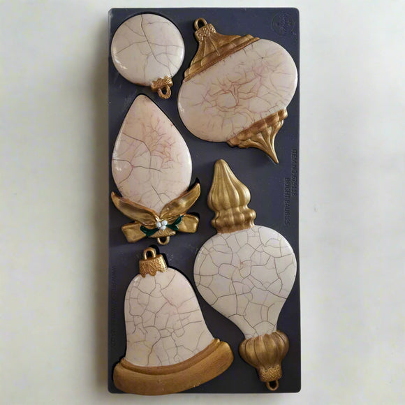Decorative ceramic castings with cracked texture on a silicone mold.