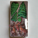 Silicone mold with tree and deer designs on a textured surface