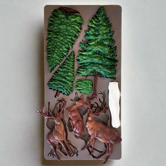 Silicone mold with tree and deer designs on a textured surface