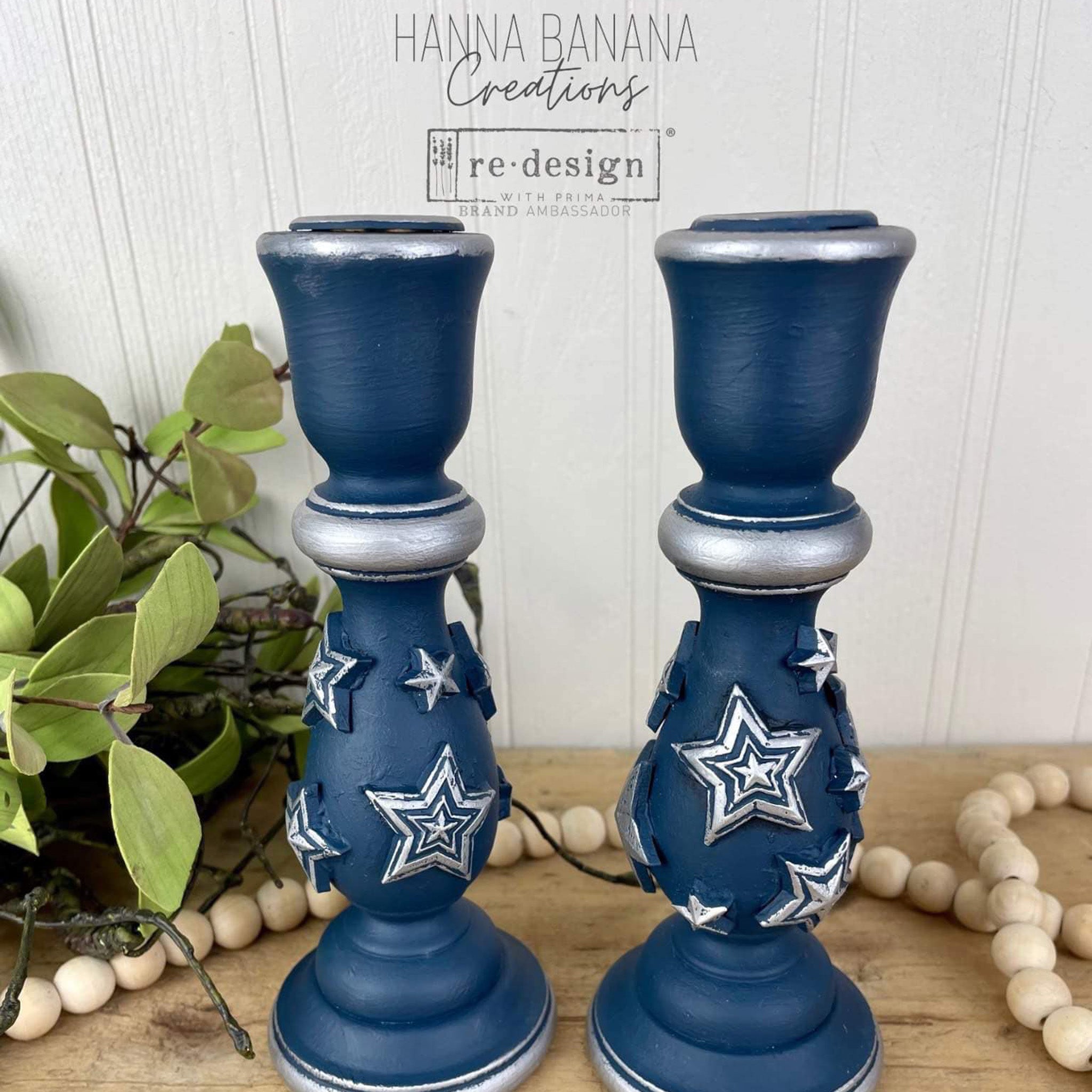 Two candle stick holders refurbished by Hanna Banana Creations are painted blue and silver and features ReDesign with Prima's Red, White, and Blue silicone mold star castings on them.