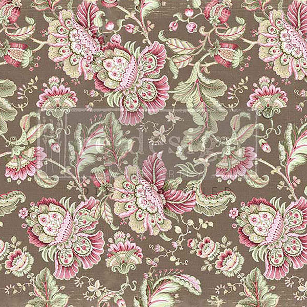 Close-up of a tissue paper design that features pink and green paisley inspired flowers and vines against a light brown background.