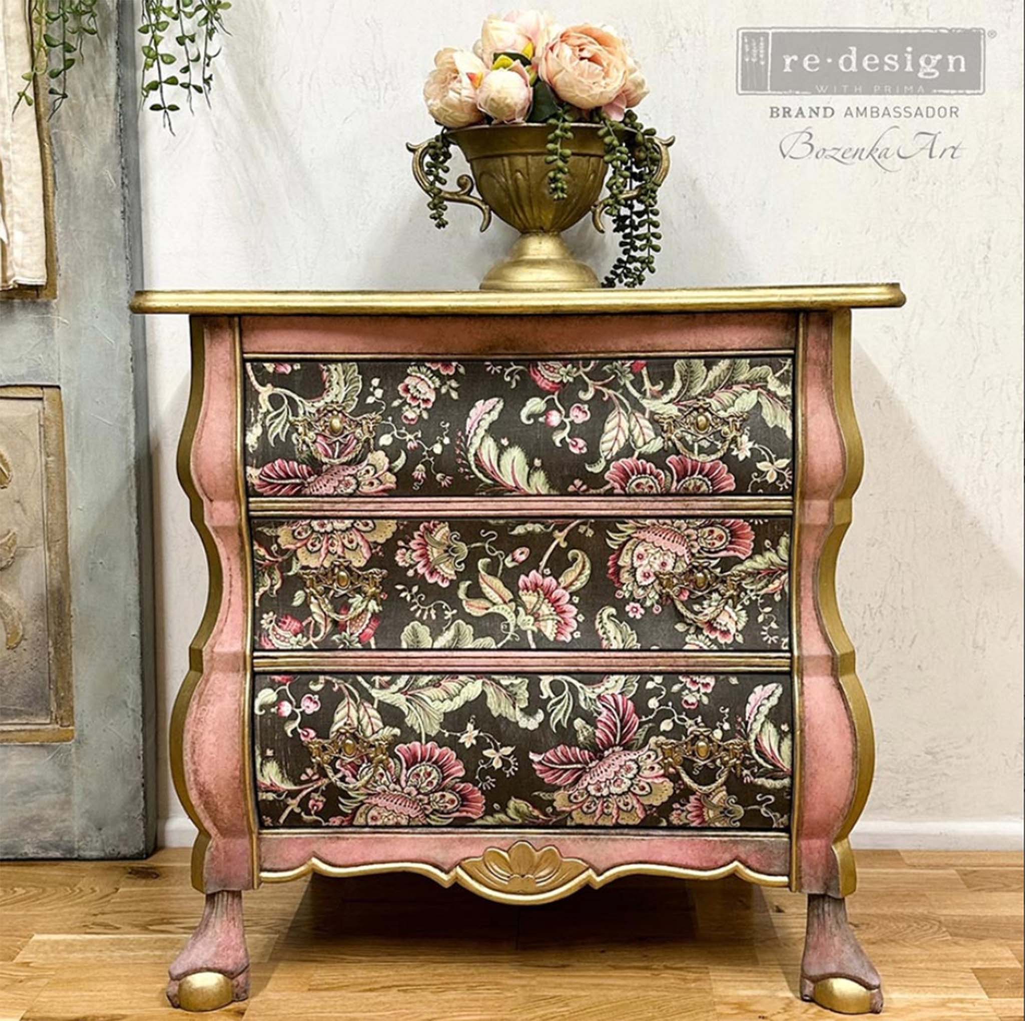 A vintage 3-drawer side table is painted rose gold with gold accents and features Floral Paisley on the drawers. At the top right is a watermark that reads: Bozenka Art. Re-design Brand Ambasador.