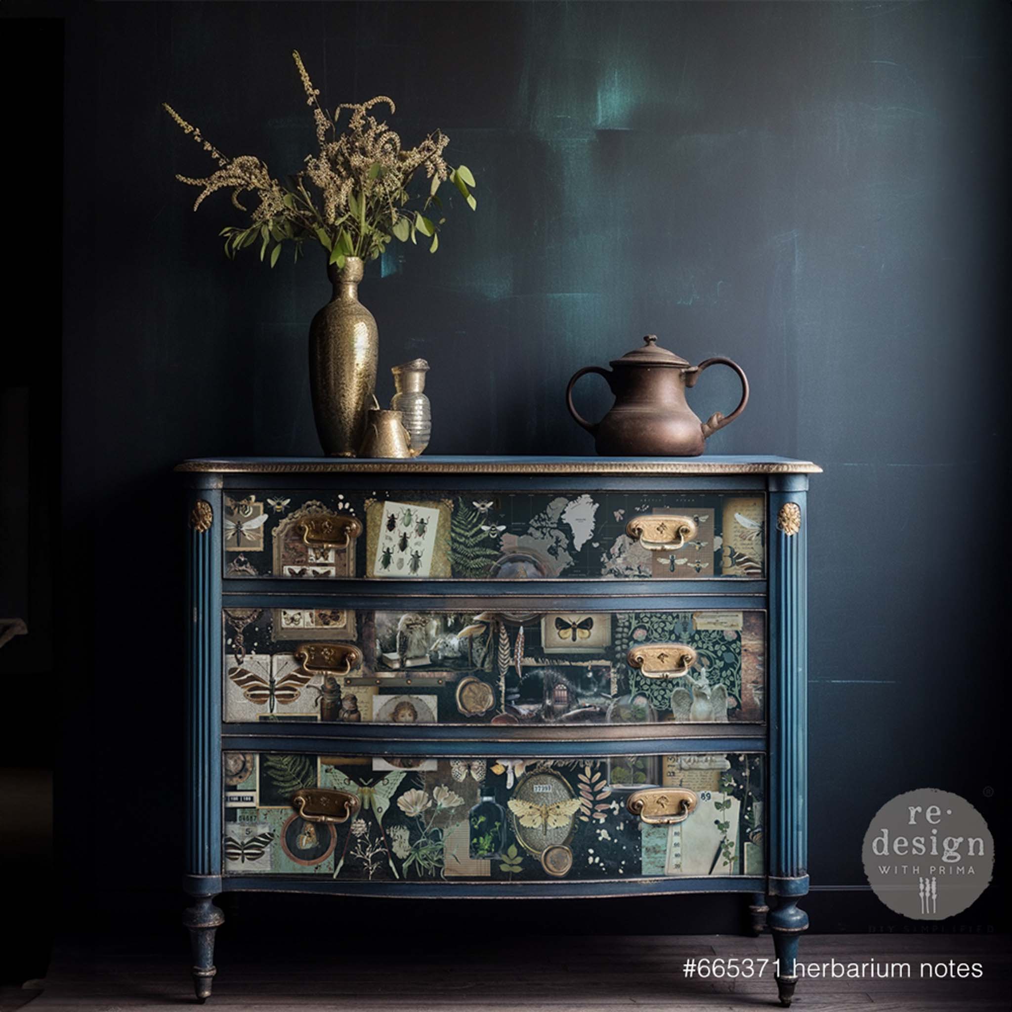 A 3-drawer dresser is painted blue and features ReDesign with Prima's Herbarium Notes tissue paper on the drawers.