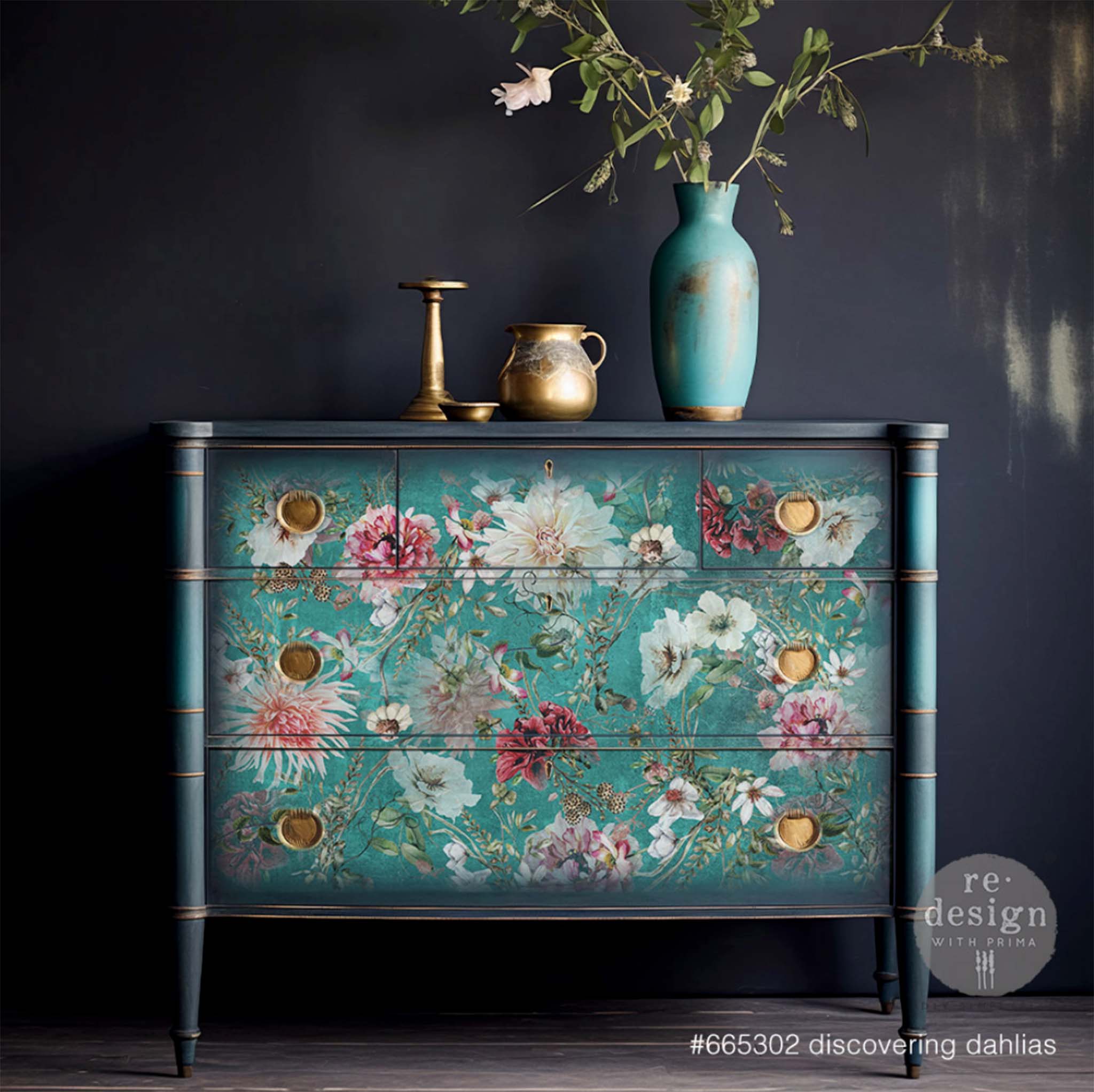 A vintage dresser is painted dark blue and features Redesign with Prima's Discovering Dahlias tissue paper on the drawers. 