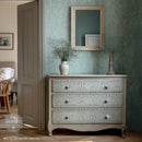 ReDesign with Prima Jardin Secret furniture transfer on a soft neutral dresser with pale blue-green French toile pattern, cottagecore decor, and botanical wall details.