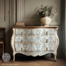 ReDesign with Prima Jardin Secret rub-on furniture transfer on a cream bombe dresser with sage green French toile medallions, ornate gold details, and vintage brass hardware.