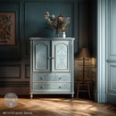 ReDesign with Prima Jardin Secret furniture transfer applied to a pale blue armoire with cabinet doors and drawers in a moody French country room.