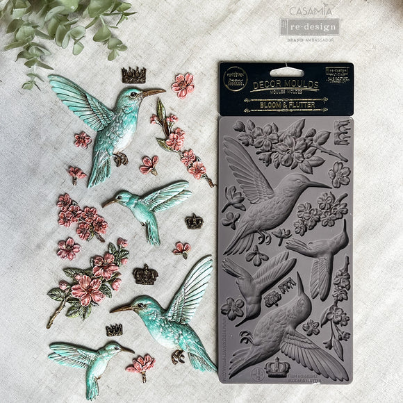 Bloom & Flutter Decor Mould with painted turquoise hummingbird, pink flower castings, crowns and silicone mold packaging