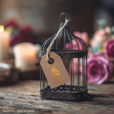 Gold Chant Du Matin water slide transfer used on a kraft tag hanging from a vintage birdcage with romantic French decor styling