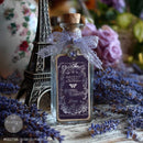 Glass bottle decorated with Eclat Du Matin silver French label water slide transfer, lavender ribbon, Eiffel Tower, and vintage Paris decor