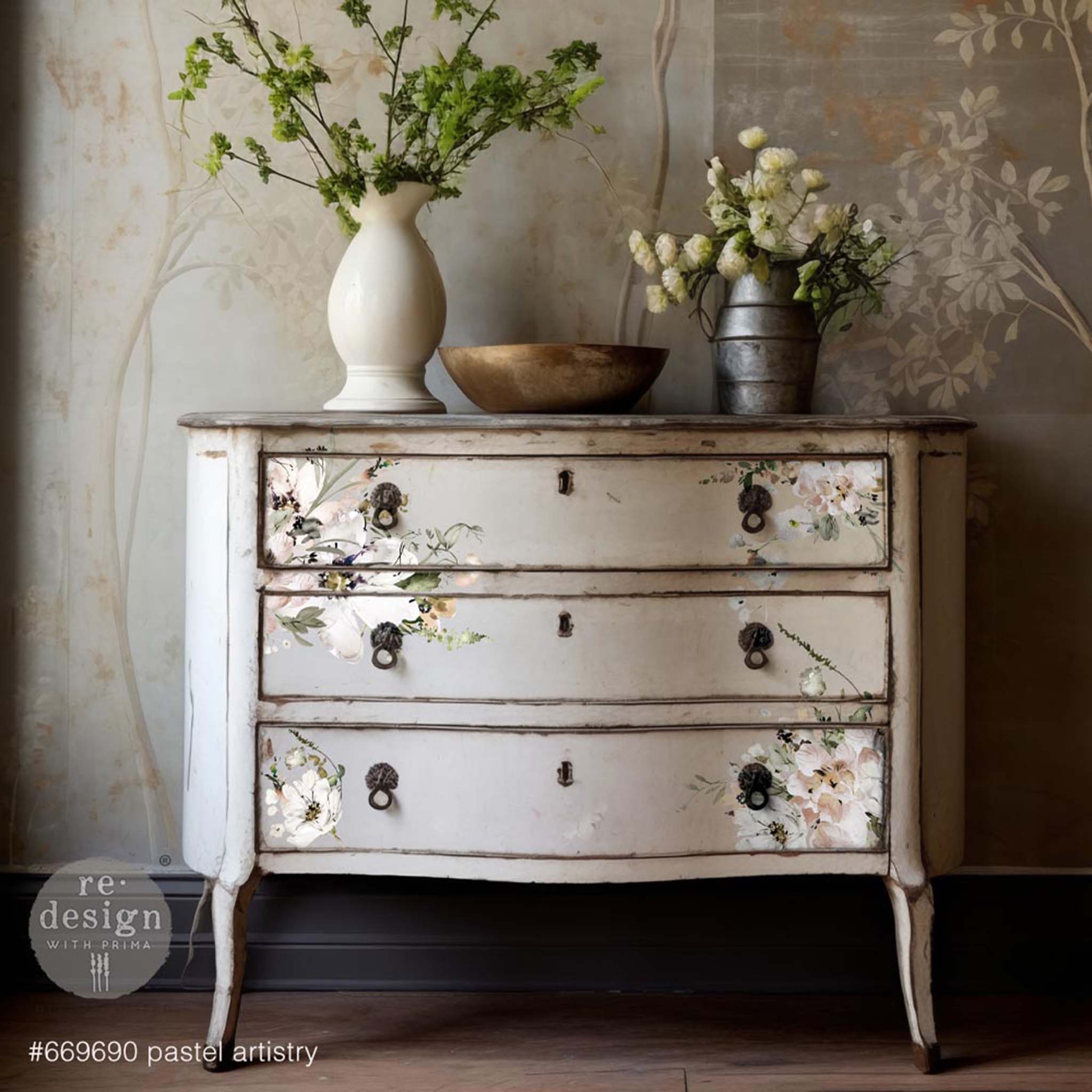 A vintage 3-drawer dresser is painted white and features ReDesign with Prima's Pastels Artistry transfer on its drawers.