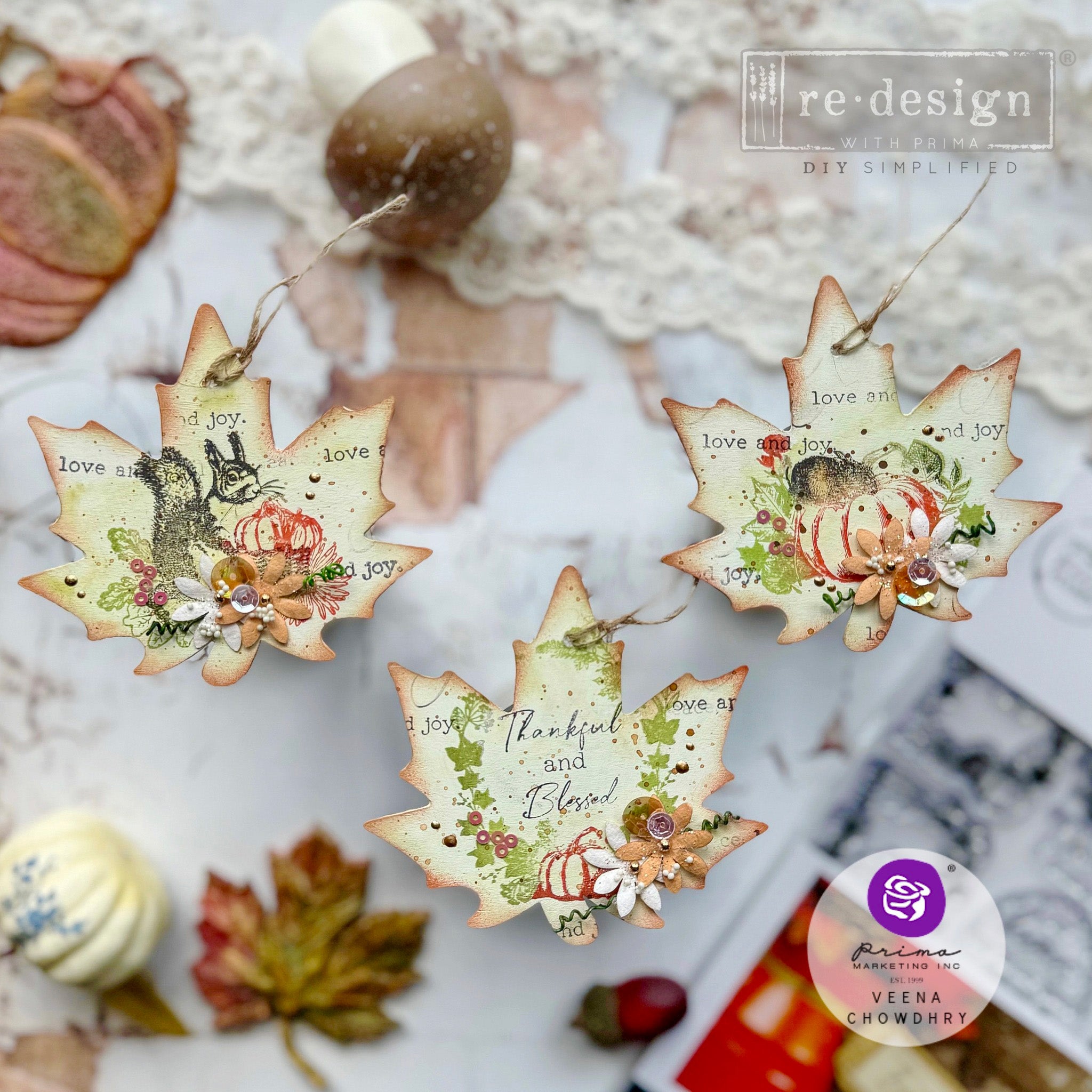 Three fall leaves ornaments created by Veena Chowdhry and feature ReDesign with Prima's Fall Sweet Fall clear decor stamps on them.