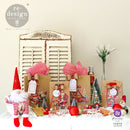 Brown paper bags with white gift tags created by Tanya Cloete feature ReDesign with Prima's Santa's Helper Tags clear decor stamps on them.