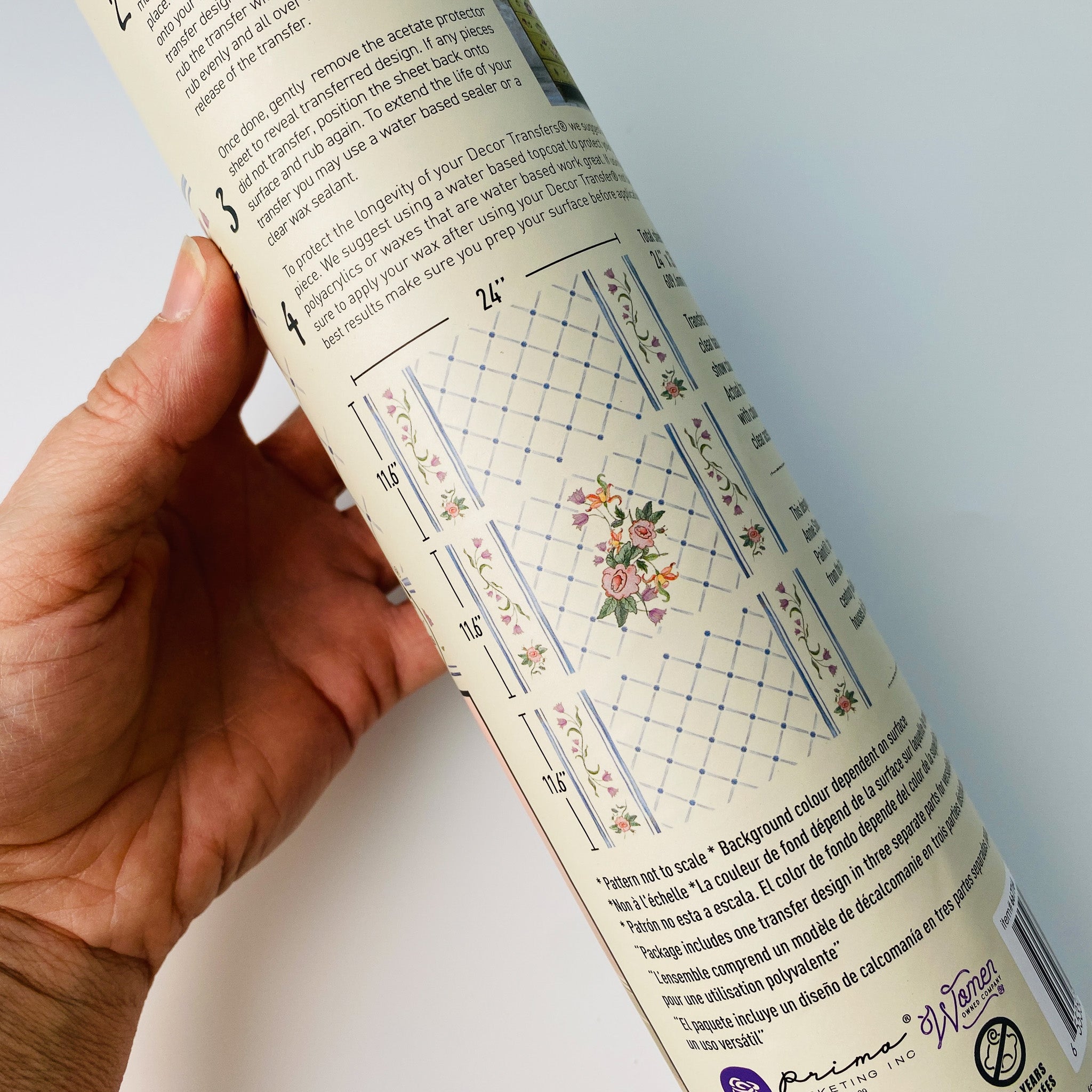A hand is shown holding the tube that shows the measurements of 3 sheets of ReDesign with Prima's Annie Sloan Swedish Posy furniture transfer.