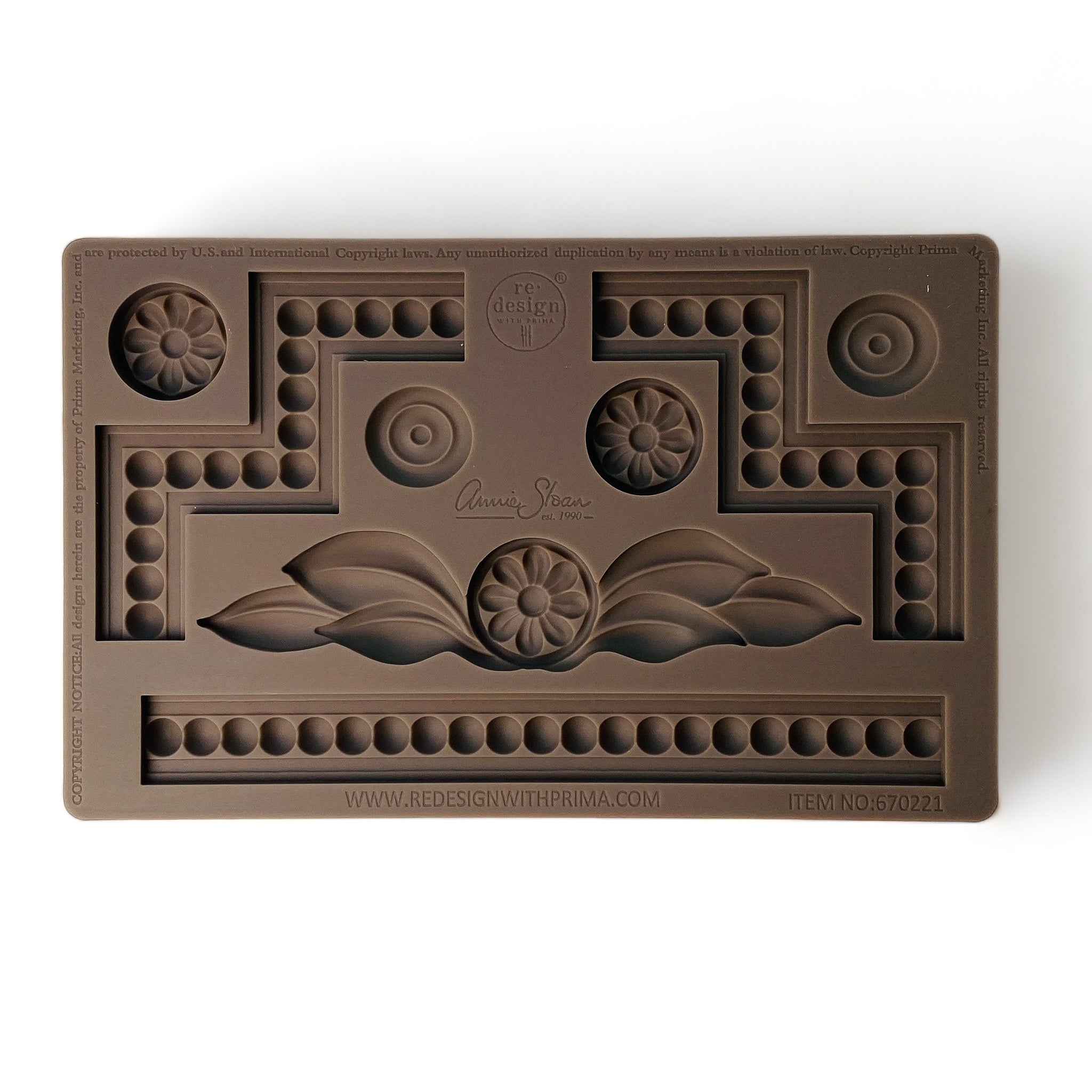 A brown silicone mold featuring unique edge pieces, borders, and multiple small floral medallions are against a white background.