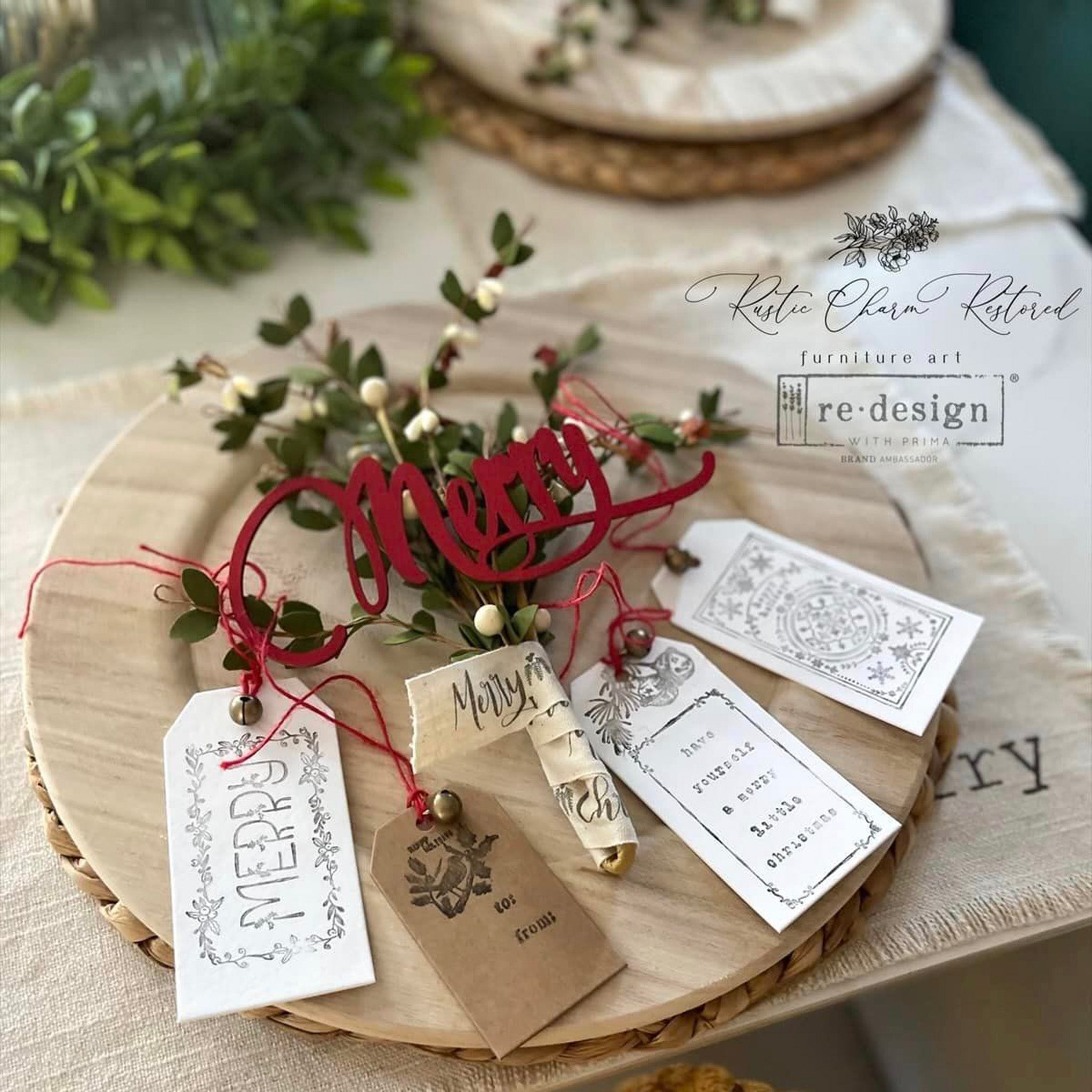 A round wood plate features 4 ReDesign with Prima Christmas Chipboard Tags created by Rustic Charm Restored.