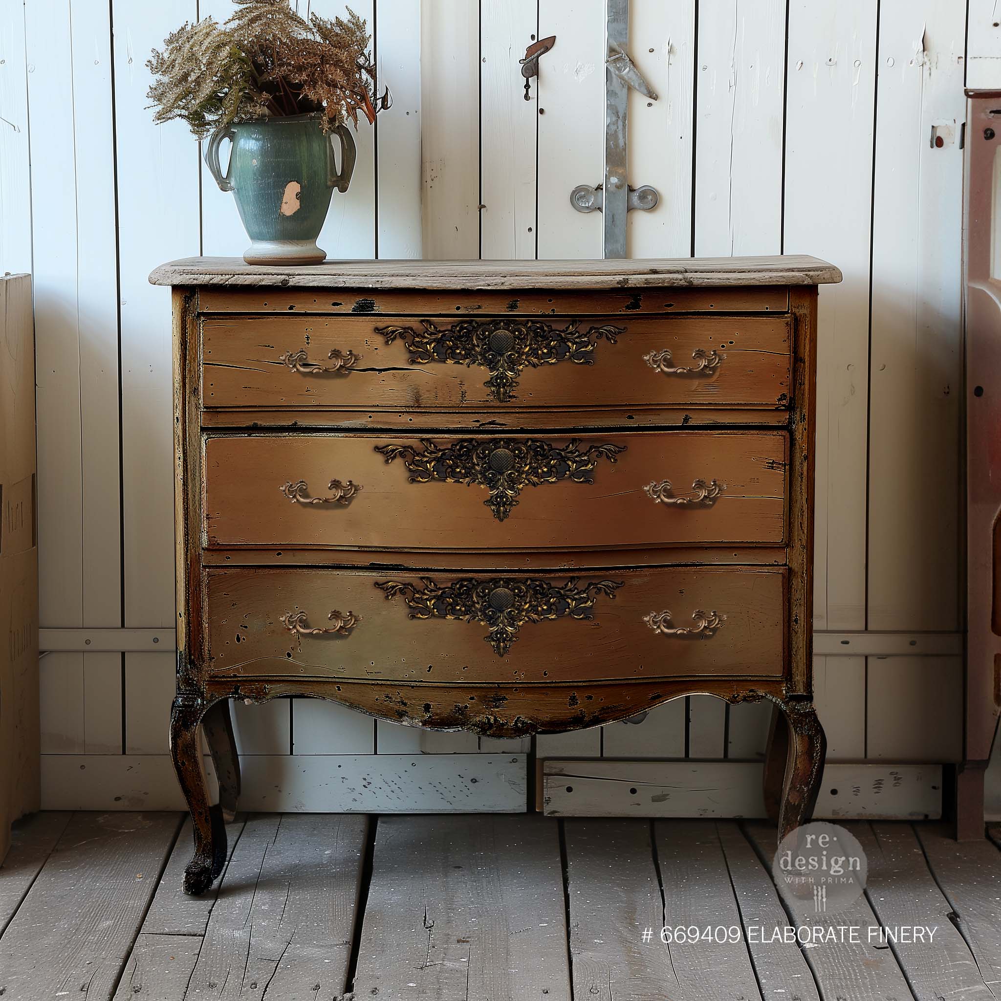 A vintage 3-drawer dresser is painted brown and features ReDesign with Prima's Elaborate Finery Decor Poly Casting at the top center of each drawer.