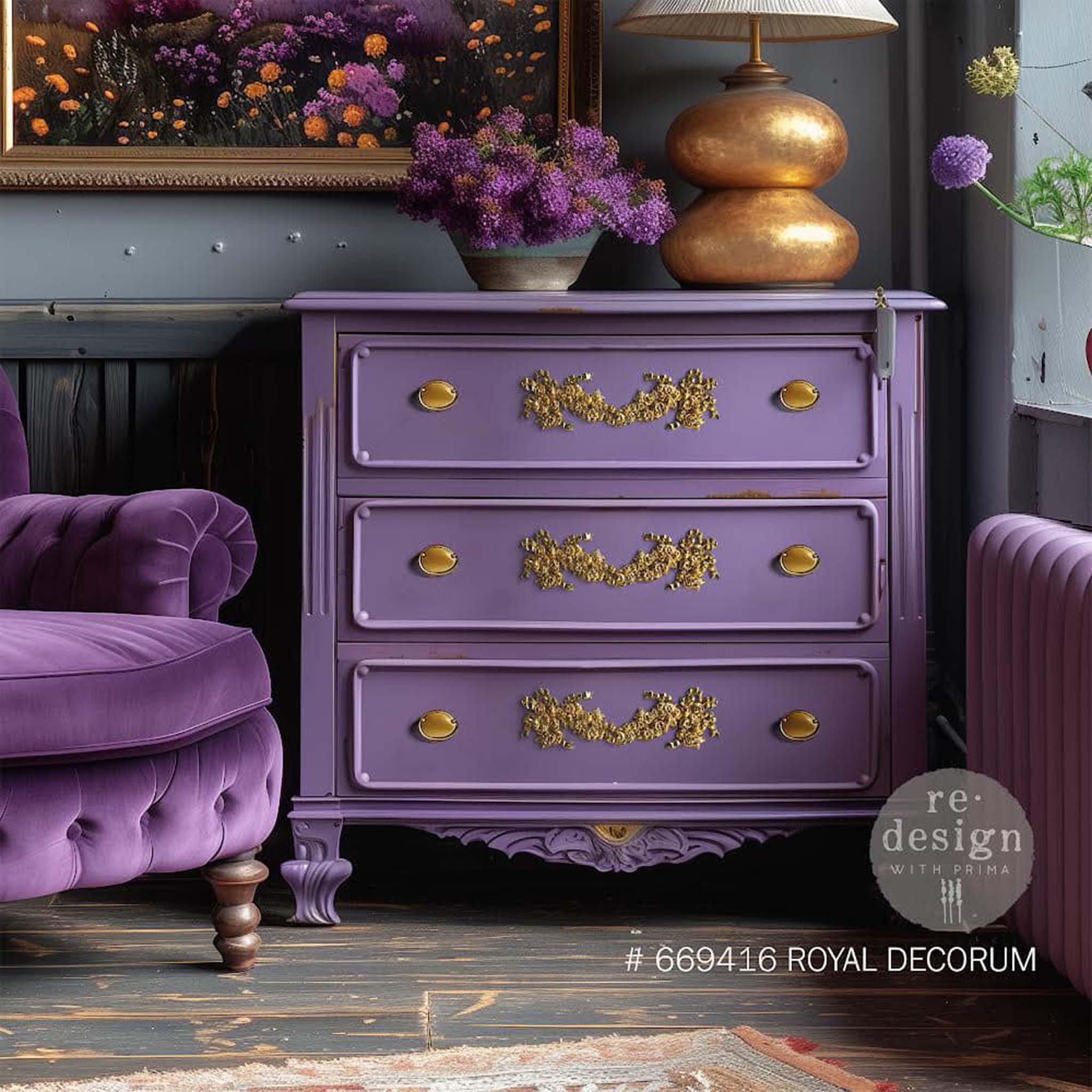 A vintage 3-drawer dresser is painted lavender with gold accents and features ReDesign with Prima's Royal Decor Poly Casting in the center of the drawers.