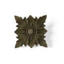 A bendable furniture applique featuring a design of a scalloped edge square beneath a 4 petaled flower shaped flourish is against a white background.