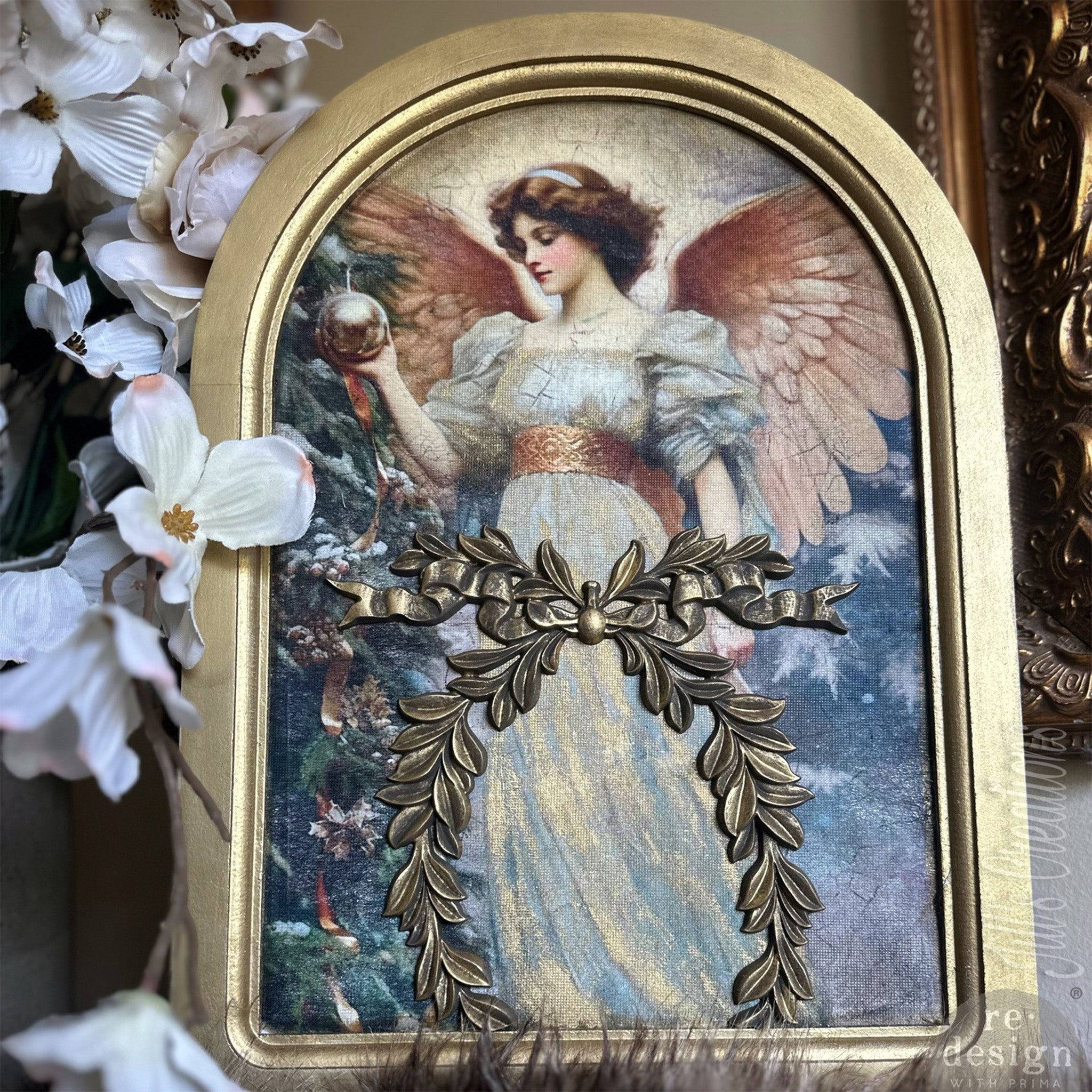 An arch photo of a Christmas angel features ReDesign with Prima's Delicate Motif decor poly casting painted gold on it.