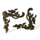 Two bendable furniture appliques that feature corner flourishes, adorned with delicate leaves and flowers are against a white background.