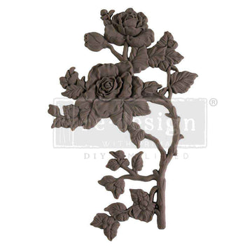 A flexible decor poly casting featuring a thorned branch of 2 roses with leaves facing right is against a white background. 