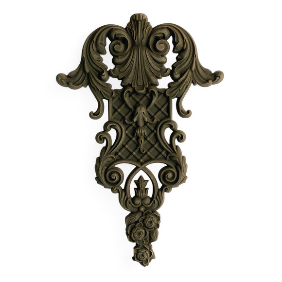 A bendable furniture applique that features intricate flourishes, a lattice center, and floral accents is against a white background.