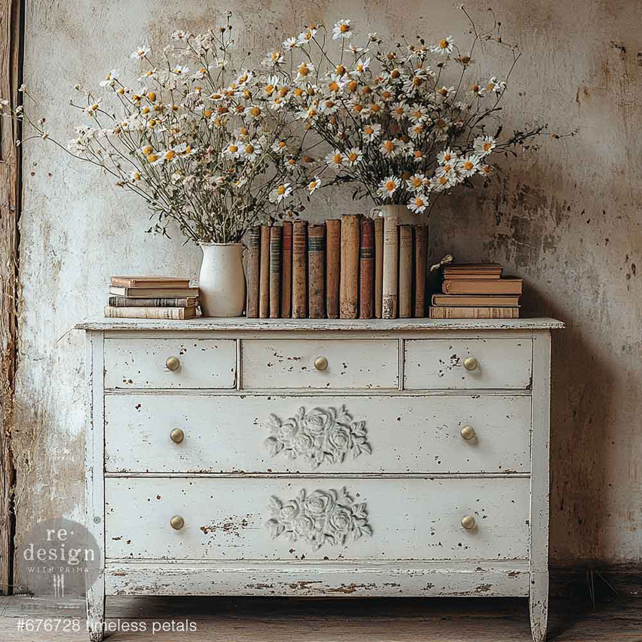 A weathered white 5-drawer dresser features ReDesign with Prima's Timeless Petals Poly Decor bendable furniture applique on the 2 large bottom drawers.