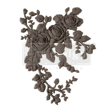 A flexible decor poly casting featuring 3 roses with hanging branches curving to the left is against a white background. 