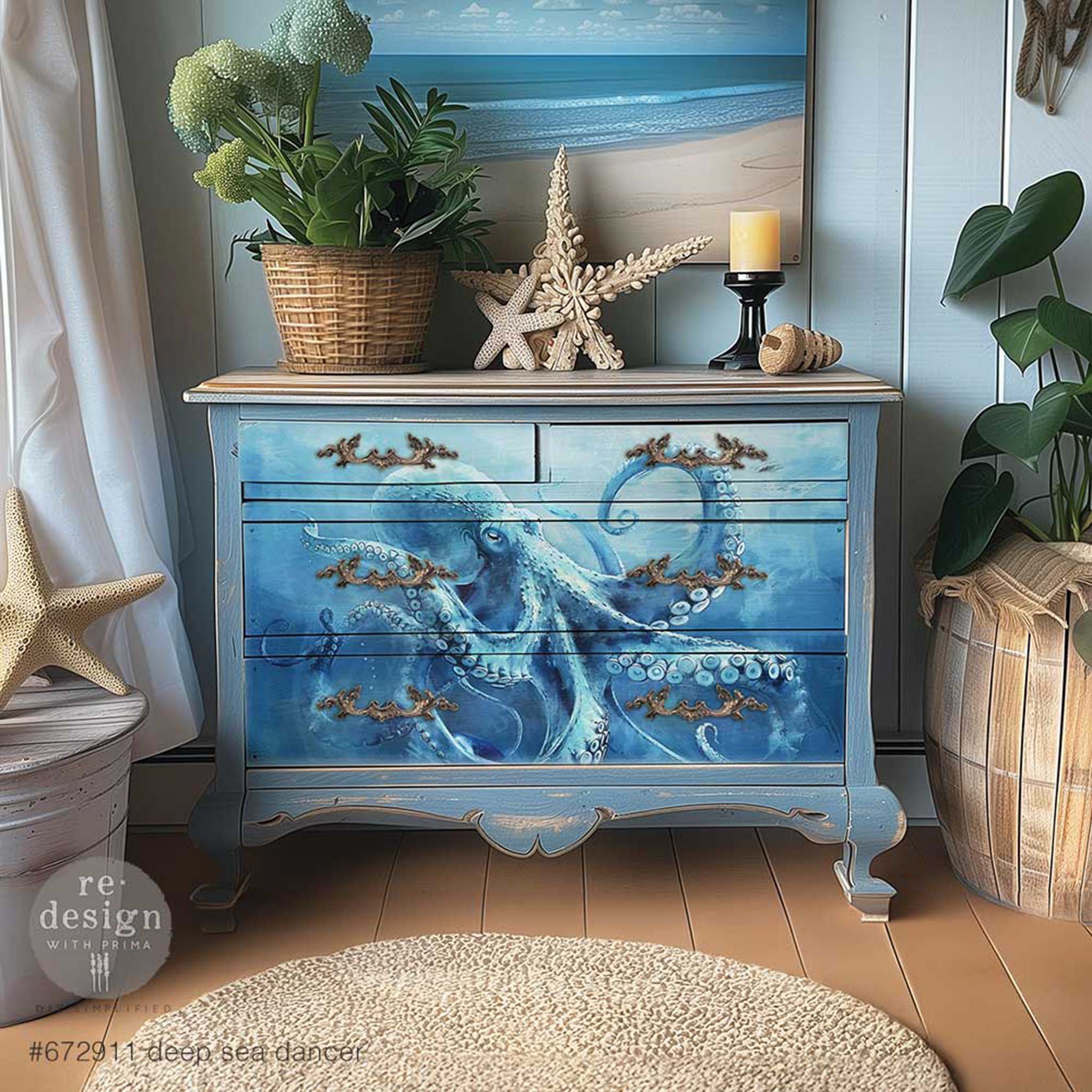 A 4-drawer dresser is painted light blue and features ReDesign with Prima's Deep Sea Dancer A1 fiber paper on its drawers.