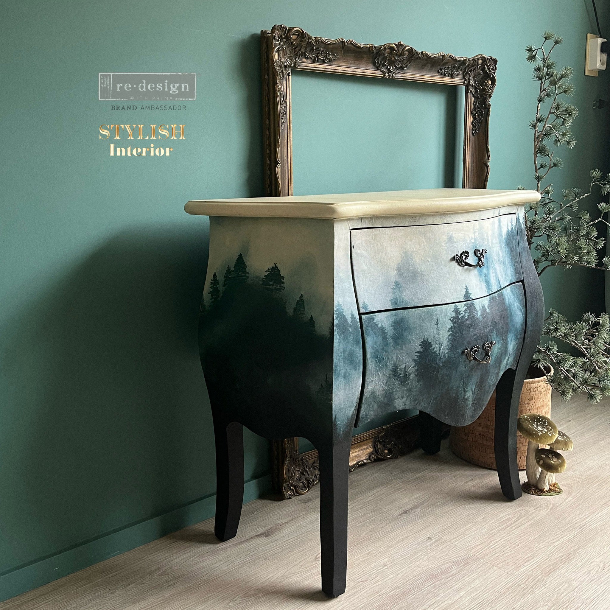 A side angle view of a vintage Bombay style 2-drawer nightstand refurbished by Stylish Interior features ReDesign with Prima's Pine Grove Hues A1 fiber paper on it.