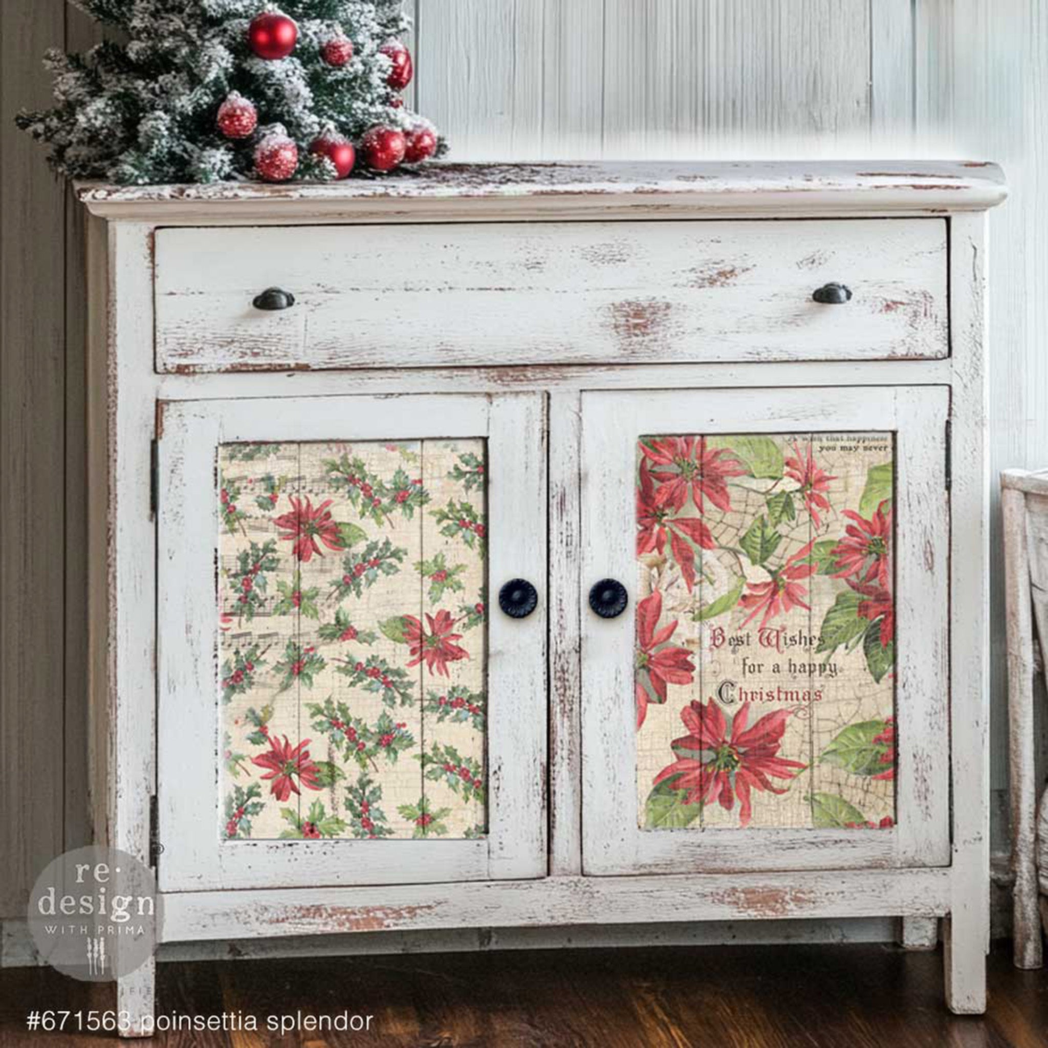 A small buffet cabinet is painted a distressed white and features 2 sheets of ReDesign with Prima's Poinsettias A3 fiber papers on the 2 door inlays.