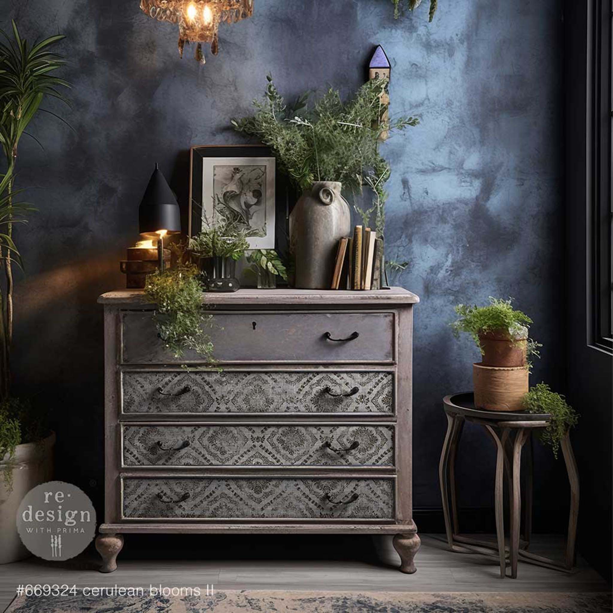 A vintage 4-drawer dresser is painted grey and features ReDesign with Prima's Cerulean Blooms 2 on its bottom 3 drawers.