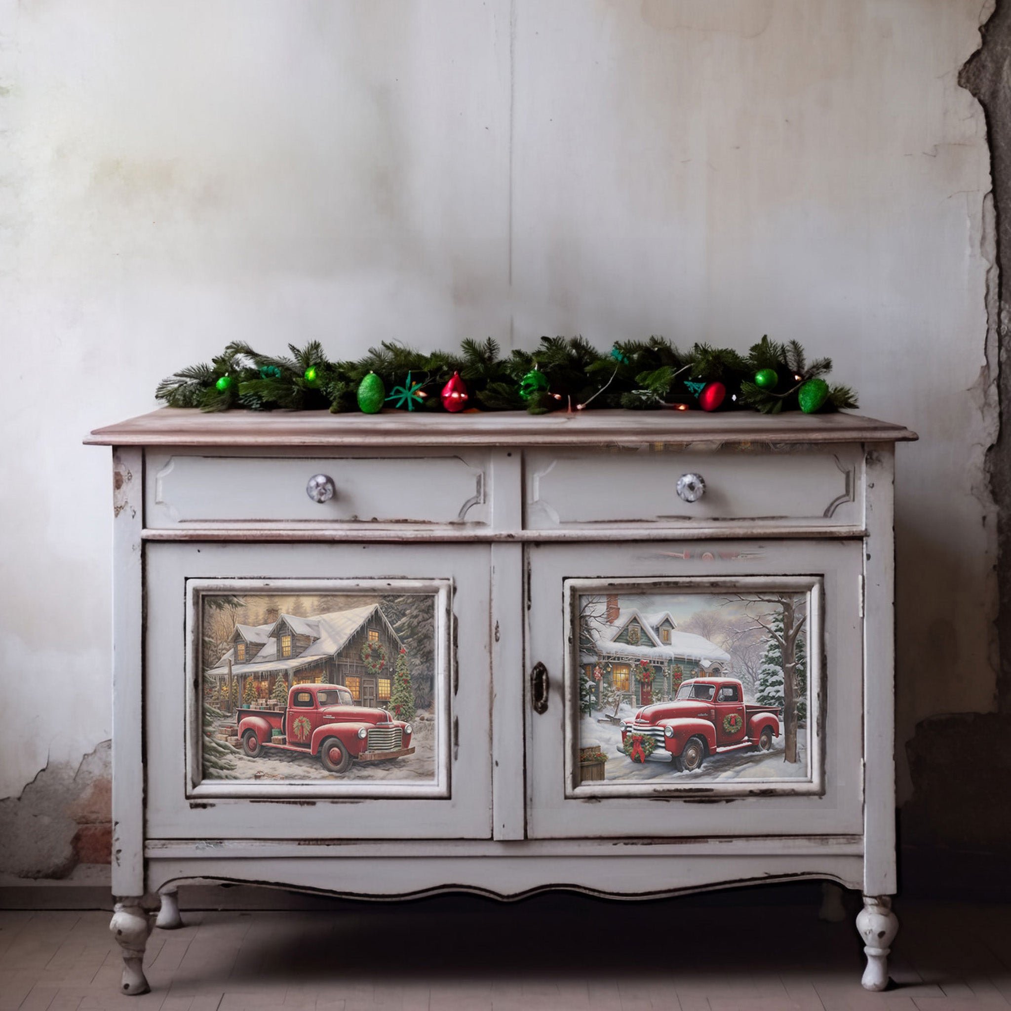 A vintage small buffet console table is painted light grey and features 2 of ReDesign with Prima's Christmas Cargo fiber papers on its 2 door inlays.